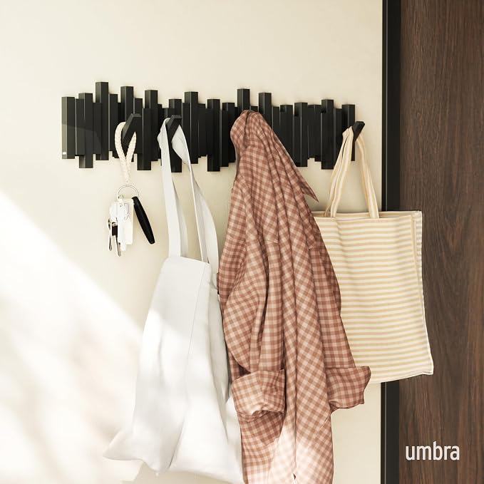 Umbra Sticks Wall Coat Rack, Wall Mount 8 Retractable Hooks, Black | Modern sculptural look, holds five pounds each, fits entryways and bedrooms, easy to install, recycled plastic