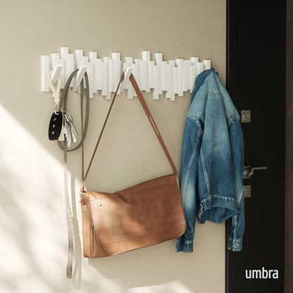 Umbra Sticks Wall Coat Rack, Wall Mount 8 Retractable Hooks, White | Modern sculptural look, holds five pounds each, fits entryways and bedrooms, easy to install, recycled plastic